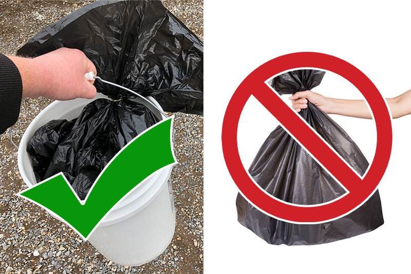 Black garbage bad carried in a white five gallon bucket. a green check mark shows this is correct. A black garbage bag is being carried by itself and a red slash says this is not correct.