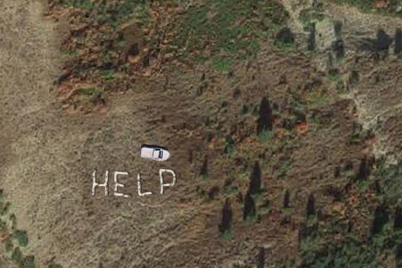 A white car is parked on a grassy area next to large letters spelling out the word "HELP" made from white objects.