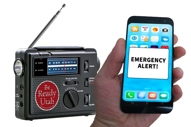 An AM/FM radio with a Be Ready Utah logo on it next to a hand holding a smart phone with the words "Emergency Alert!" on the screen.