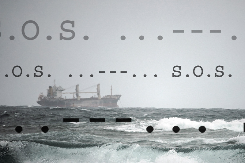 A cargo ship is seen on the ocean with Morse code for S.O.S. displayed above the waves.