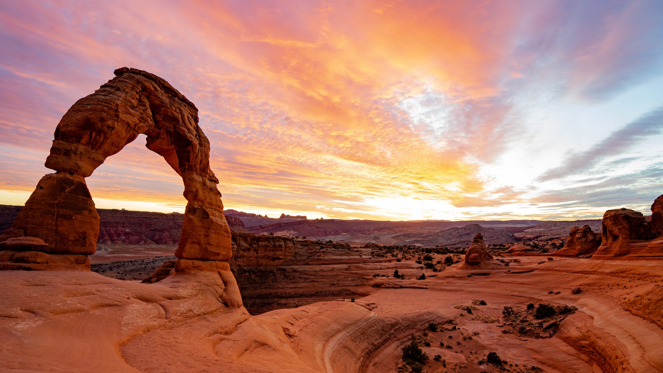 desert landscape at sunset with a sandstone arch